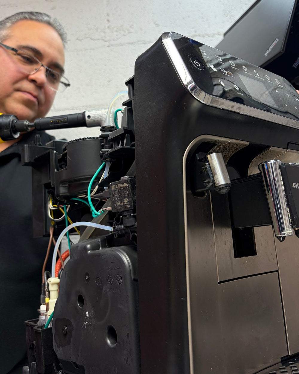 An automatic espresso machine opened up for repair in the Torréfactorie workshop